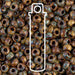 Close-up of picasso brown tan matte Miyuki 6/0 seed beads with a tube outline icon overlaid