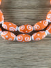 Hidden Gems: Orange Swirl Oval Java Glass Beads
