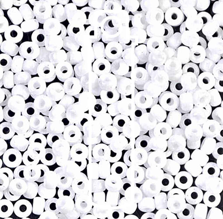 Close-up of opaque white Miyuki 8/0 glass seed beads with visible holes, piled together