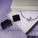 Anti-tarnish tabs beside an open white gift box with a silver bracelet, on a ruler mat showing size