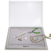 Bead mat tray with clear cover lifted above beading tools, tube of seed beads and a beaded necklace on the mat