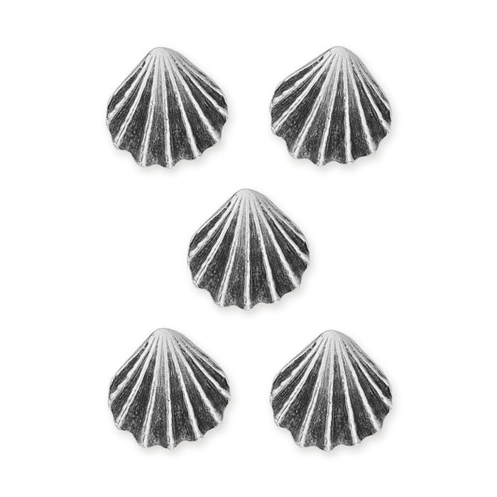 Antiqued silver scallop shell buttons, five pewter buttons arranged in a group on white