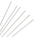 Close-up of six slender size 12 English beading needles showing their long narrow eyes