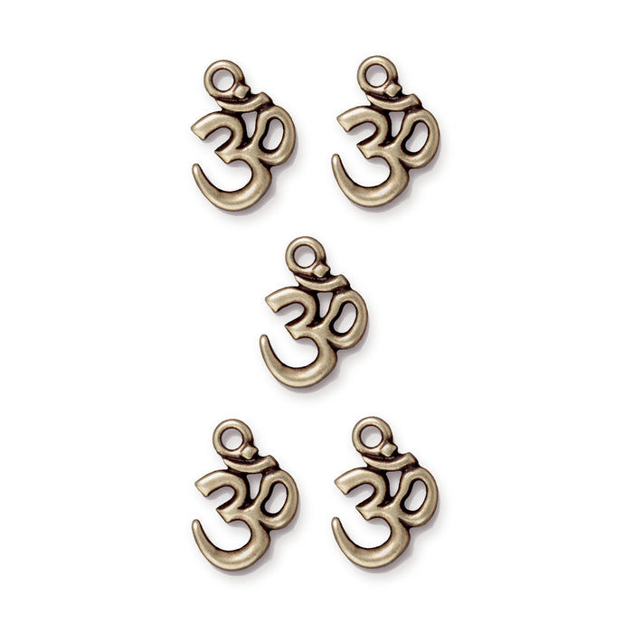 Antiqued brass open Om charms arranged in a group of five on a white background