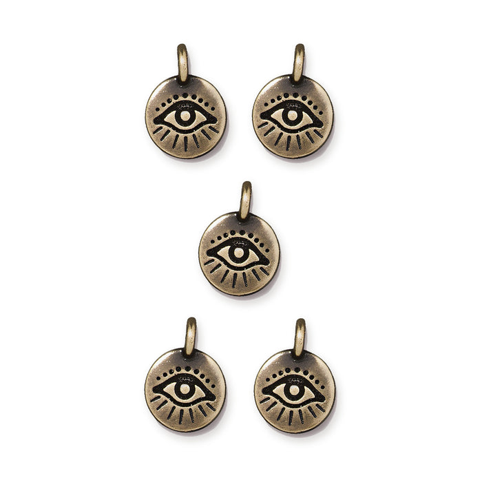 Antiqued brass evil eye charms, five round pewter charms with loops arranged in a group on white