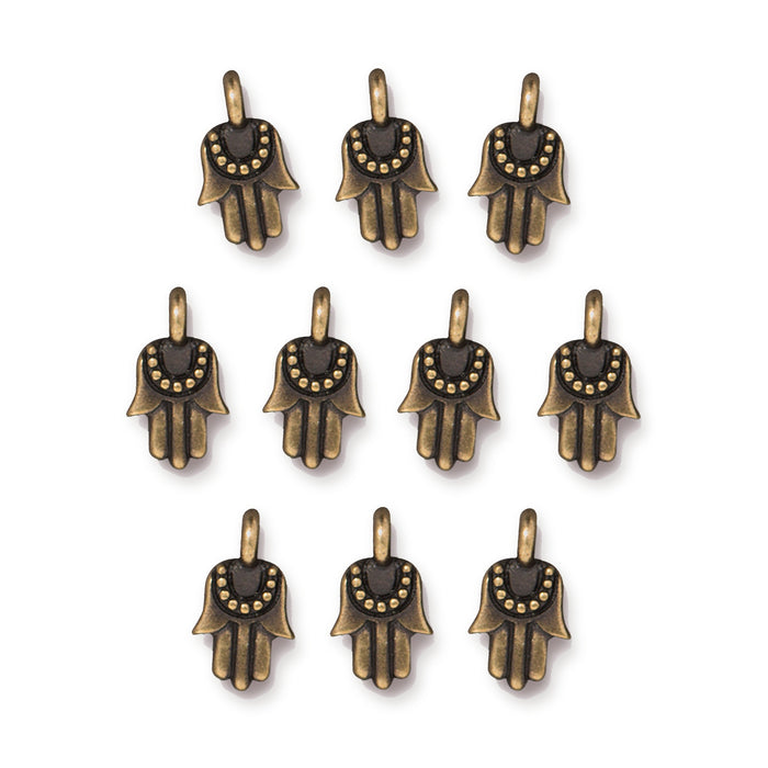 Antiqued brass miniature hamsa charms arranged in rows of ten on a white background