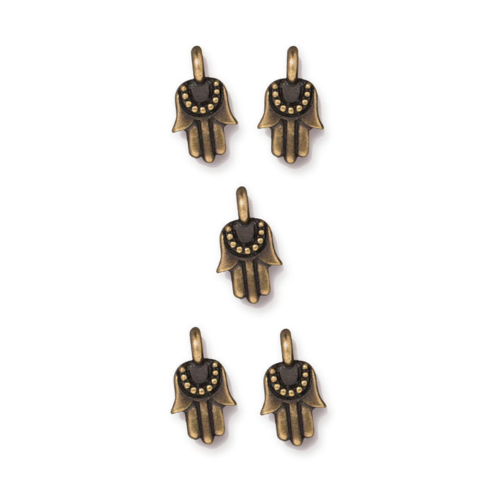 Antiqued brass miniature hamsa charms, five pewter charms arranged in a group on white