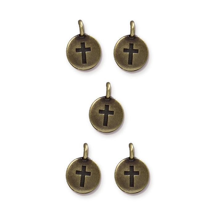 Antiqued brass cross charms, five round pewter charms with loops arranged in a pattern on white