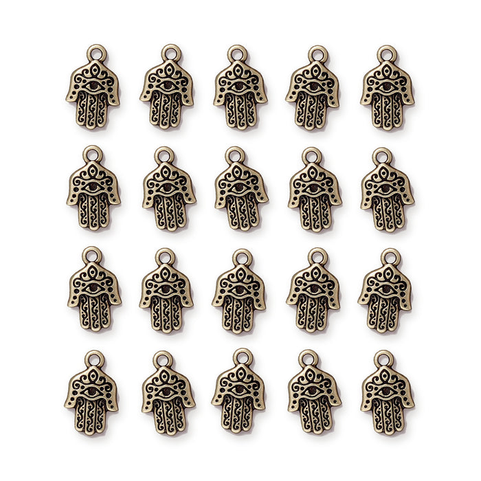 Antiqued brass hamsa hand charms arranged in four rows of five, showing the eye and scroll detailing
