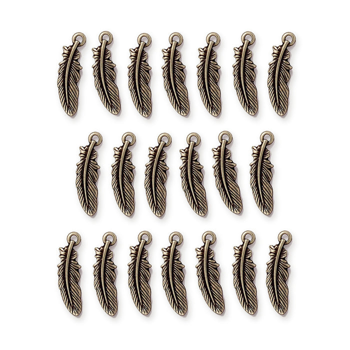 Antiqued brass pewter feather charms arranged in three rows on white, 20 charms shown