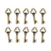 Antiqued brass key charms with trefoil bows, ten arranged in two rows