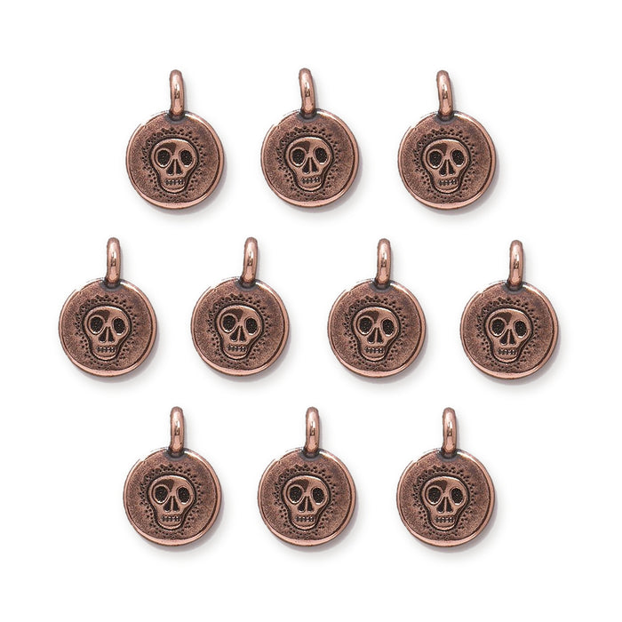 Antiqued copper skull charms, ten round pewter pieces with loops arranged in rows