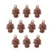 Antiqued copper hamsa hand charms with eye and scroll detail, ten charms arranged in rows on white