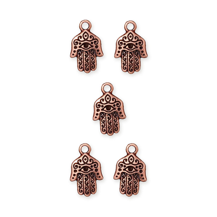 Antiqued copper hamsa hand charms with eye and scroll detail, five charms arranged in a group