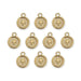 Ten gold plated round cross motif pendants with loops laid out in rows on a white background