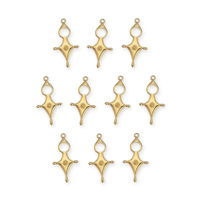 Ten gold plated Tuareg cross motif pendants arranged in rows on a white background