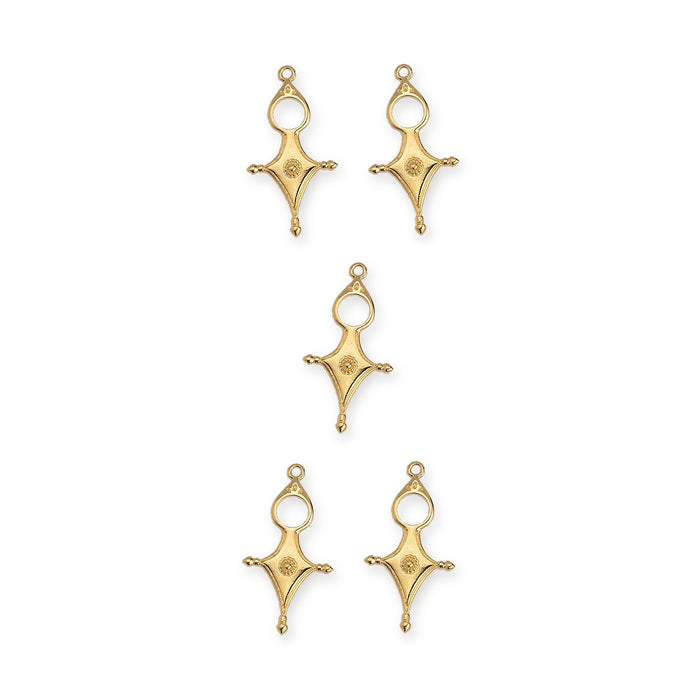 Gold plated Tuareg cross motif pendants, five pieces arranged in a group on white