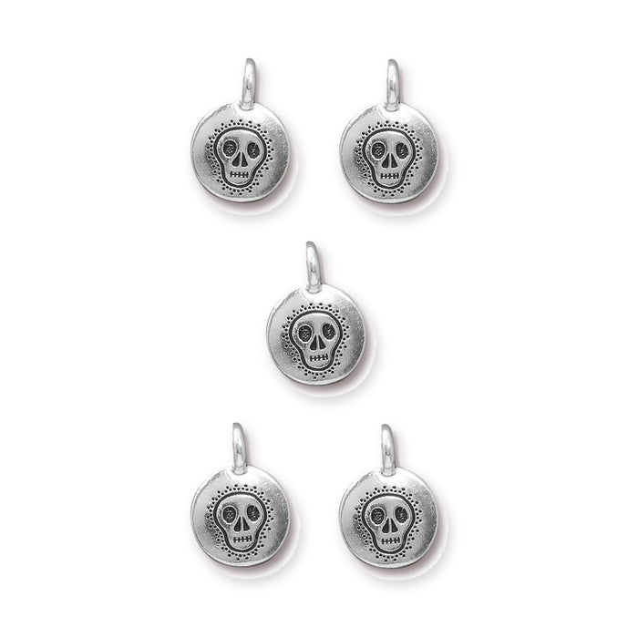 Antiqued silver skull charms in pewter, five round charms with loops arranged in a grid