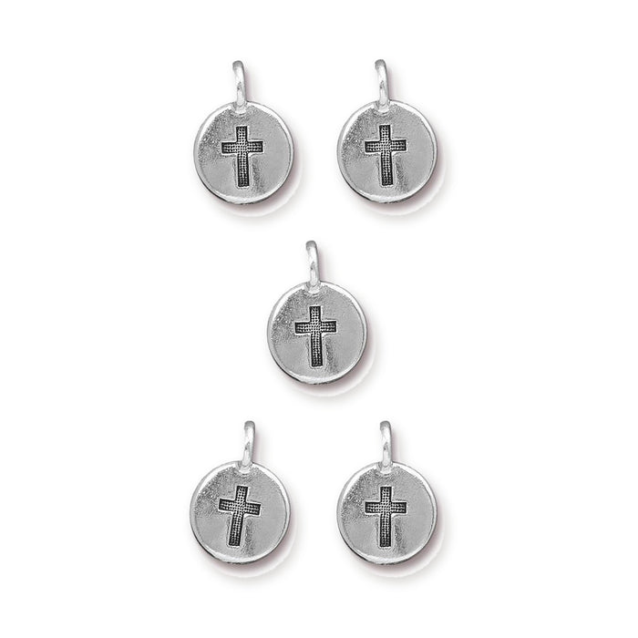 Five antiqued silver pewter cross charms with round discs and loops arranged in a group on white