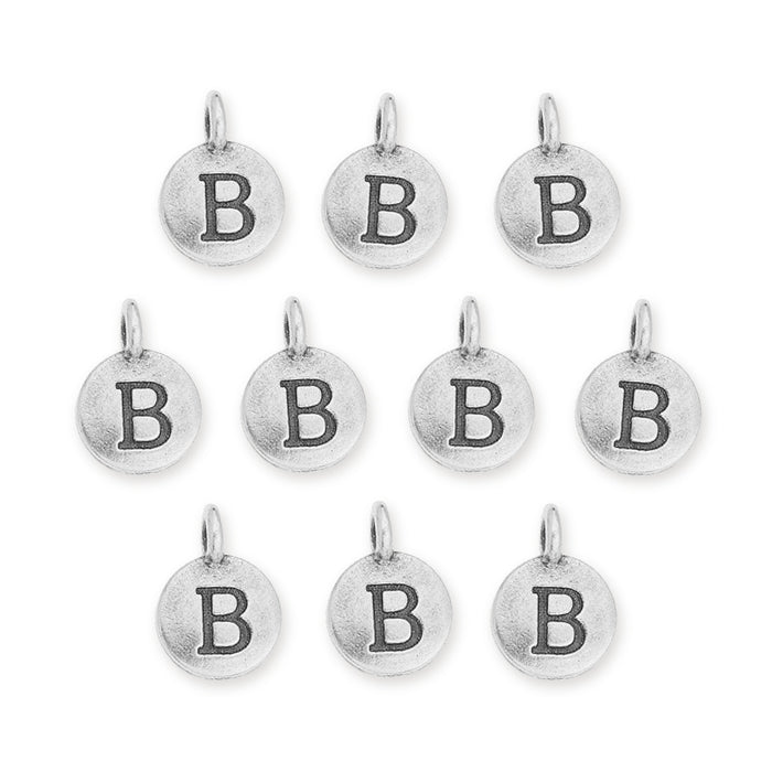 Antiqued silver letter B charms, ten round pewter charms with loops laid out in rows on white