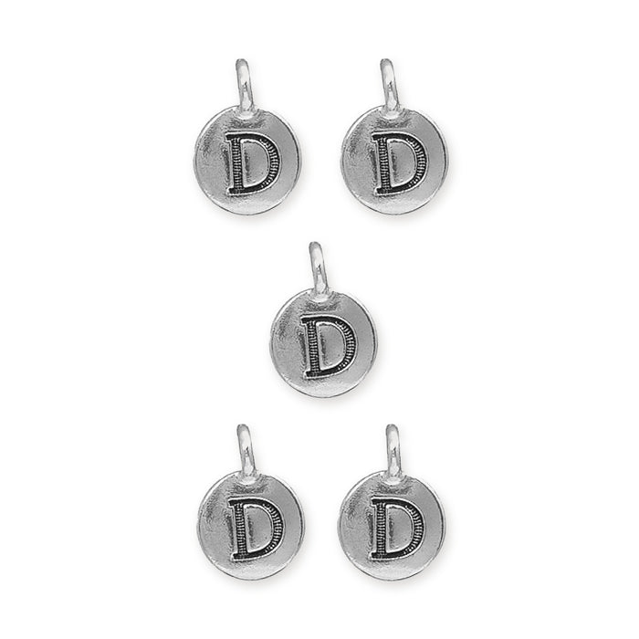 Antiqued silver letter D charms, five round pewter charms with loops arranged on white