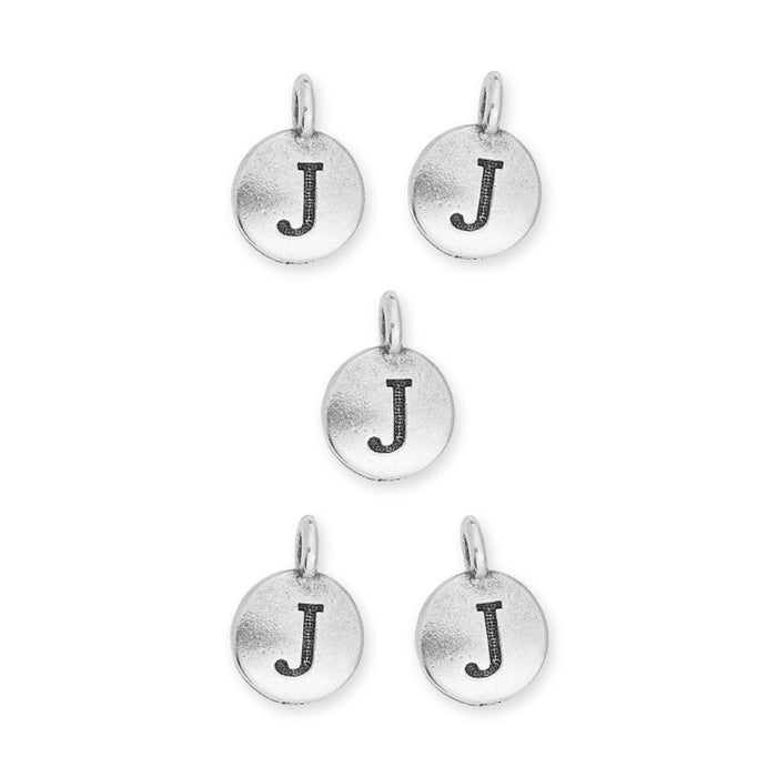 Antiqued silver letter J charms, five round pewter discs with loops arranged in a group on white