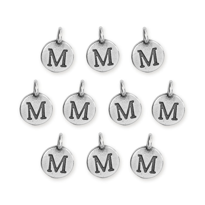 Antiqued silver letter M charms, ten round pewter charms with loops laid out in rows
