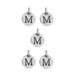 Antiqued silver letter M charms, five round pewter discs with loops arranged in a pattern on white