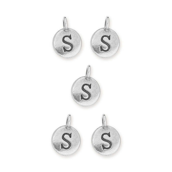 Antiqued silver letter S charms, five round pewter charms with loops arranged on a white background