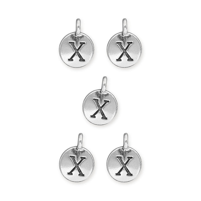Antiqued silver letter X charms, five round pewter charms with loops arranged on white