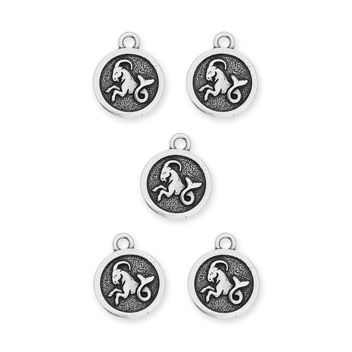 Antiqued silver Capricorn zodiac charms, five round pewter charms with sea-goat design on a white background