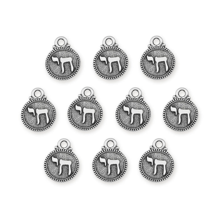 Antiqued silver chai charms, ten round pewter charms with beaded rim arranged in rows on white