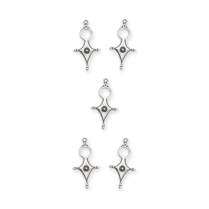 Antiqued silver Tuareg cross pendants, five pieces arranged in a group on white