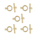 Gold plated bar and ring toggle clasp sets, five clasps with rings and bars laid out in a pattern