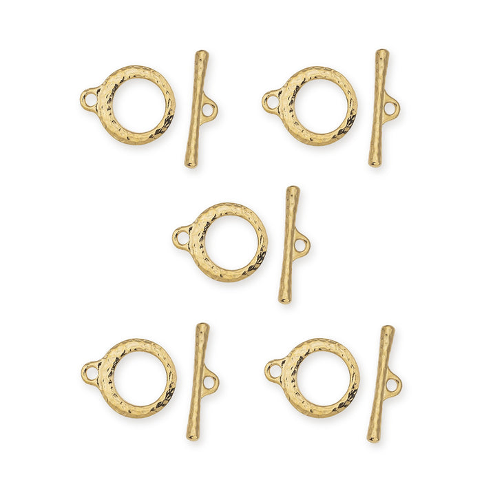 Five gold plated Craftsman toggle clasp sets, each with a hammered ring and bar, laid out on white