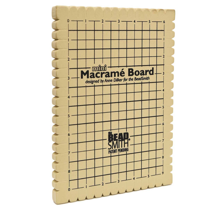 BeadSmith mini macrame board with scalloped edges and printed grid, shown at an angle from the side