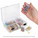 Hand holding one flip top box of beads beside the open organizer case with several boxes filled