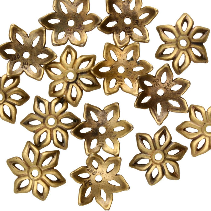 Antiqued brass flower bead caps scattered, showing six-petal cutout design