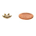 Antiqued brass flower bead cap seen from the side next to a US penny for size comparison