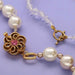 French wire used as a clasp finish on a pearl necklace with gold flower clasp and a crystal bead toggle necklace