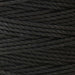 Close-up of the twisted texture of black S-Lon heavy nylon cord wound tightly on the spool