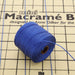 Blue nylon bead cord spool with loose cord strands on a mini macramé board