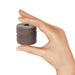 Hand holding a small spool of cocoa nylon bead cord to show its size