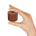 Hand holding a small spool of copper nylon bead cord to show its size