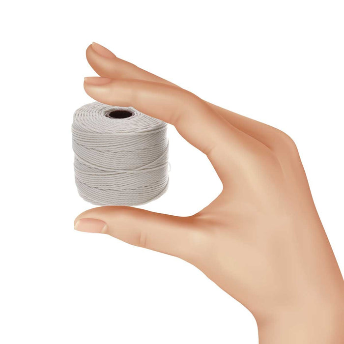 Hand holding a small spool of S-Lon cream nylon bead cord to show its size