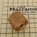 Dark tan S-Lon nylon bead cord spool on a mini macrame board with measurement grid for scale