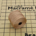 Light brown S-Lon nylon bead cord spool lying on a mini macramé board with measurement grid