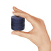 Hand holding a small spool of navy blue nylon bead cord to show its size