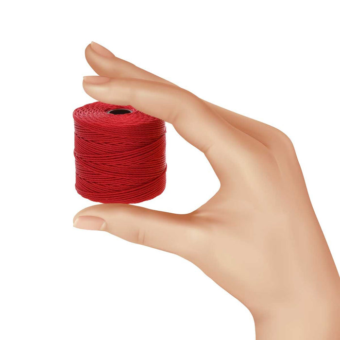 Hand holding a small spool of red S-Lon nylon bead cord for size reference