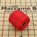 Red S-Lon nylon bead cord spool resting on a mini macramé board with cords stretched across it